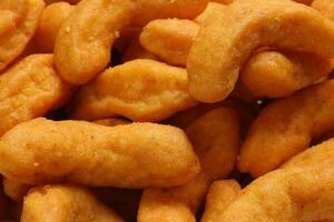 Deep fried battered onion pakoda slightly curly crispy spicy ready to eat snack photo