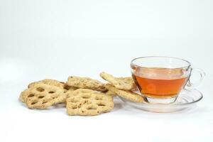 Kuih Cincin rice flower brown sugar sweet cracker snacks with cup of transparent licker tea photo