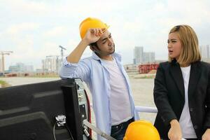 South east Asian construction worker engineer management at construction site hard safety hat helmet photo