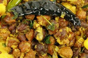 Black chickpeas chola spicy fried curry bhuna ghugni photo