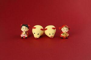 Chinese New Year rat mouse shaped cookie boy girl doll on red background photo