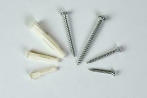 Metal screw plug on white background photo