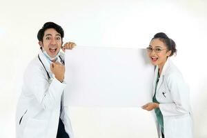 Asian Chinese Malay male female doctor holding posing showing pointing blank expression happy exited white paper board on white background photo