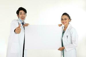 Asian Chinese Malay male female doctor holding posing showing pointing thumbs up to camera blank expression happy exited white paper board on white background photo