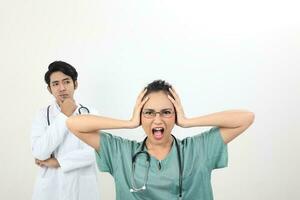 young asian malay chinese male female doctor on white background headache angry annoyed hand on head scream at camera photo