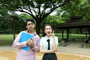 young asian malay chinese man woman outdoor park walk stand study talk discuss laptop file book backpack pose happy mingle idea photo