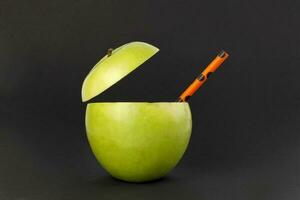 Healthy Green Cut Apple recyclable paper straw juice drink idea concept on black background photo