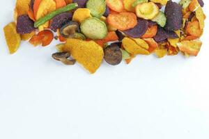 Healthy vegetable chips yellow sweet potato purple sweet potato carrot green radish green beans and shiitake mushrooms photo