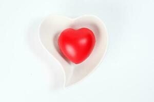 Hart Love shape plastic rubber object on white plate background photo