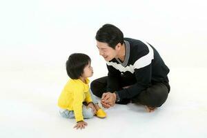 South East Asian father son child playing talking on white background boy upset photo
