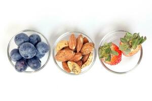 Blueberry Strawberry Herb Spice Almond Cashew Nut in glass bowl on white background photo