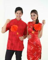 South East Asian young Malay Chinese Indian man woman wearing traditional chinse cheongsam dress on white background shop exchange gift orange greetings share racial unity harmony hand fan photo