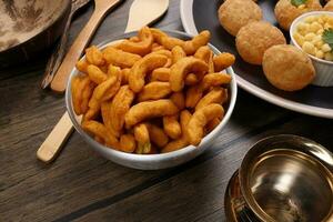 Deep fried battered onion pakoda slightly curly crispy spicy ready to eat snack photo