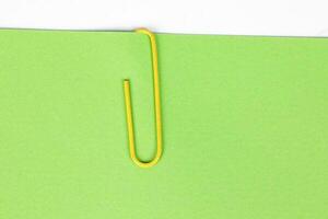 Paper clip holding on blank colour paper text copy space note photo