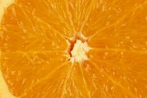 Ripe juicy orange half cut closeup on white background photo