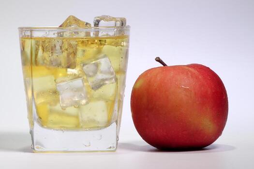 Apple Juice dripping flowing through frosted glass ice cube photo