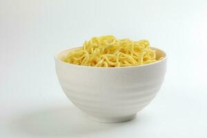 Fresh yellow egg noodle in bowl on whit background photo