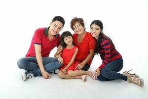 Southeast Asian multigeneration family parents daughter grandmother father mother child pose happy sit stand photo