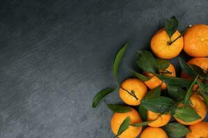 mandarin orange green leaf wood crate box top view copy text space frame on black slate background photo