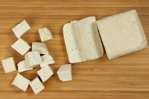 Soyabeans soya bean curd tofu wooden board block slice dice chopped photo