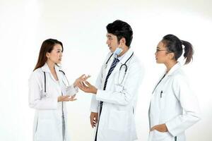 Asian Malay Chinese male female three doctors talking discussing on white background photo