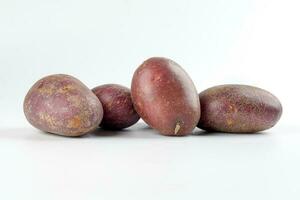 Purple color small baby potato on white background photo