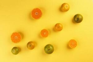 small yellow green mandarin orange whole slice on yellow background copy space for text photo