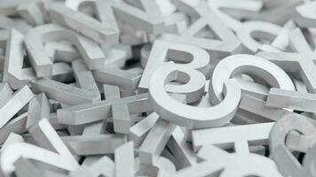 full frame close-up looped slowly rotating background of silver metal letters with selective focus video