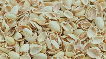 looped rotating empty pistachios shells full frame close-up background video