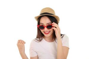 Beautiful young south east Asian woman wearing red frame sunglass eyewear hat pose fashion style white background look around copy text space photo