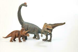 Tyrannosaurus Triceratops Brachiosaurus Dinosaur Toy figurine on white background photo