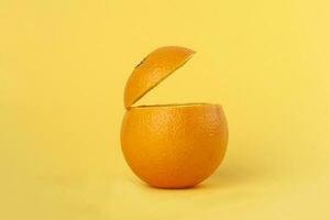 Healthy Orange Cut floating top slice juice drink idea concept on yellow background photo