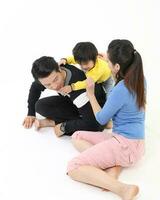 South East Asian young father mother daughter son parent boy girl child activity indoor photo