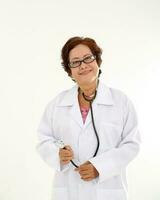 Elderly asian Chinese female doctor on white background wearing white apron stethoscope look at camera photo