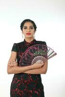South east Asian Indian race ethnic origin woman wearing Chinese dress costume Cheongsam holding hand fan multiracial community on white background photo