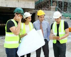 South East Asian young Malay Chinese man woman wearing safely helmet construction site work photo