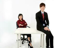 Young attractive  man woman business office white background sit on table chair pose confident look at camera smile photo