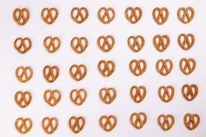 Pretzel cracker laid in rows design on what background photo