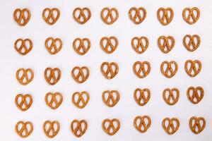 Pretzel cracker laid in rows design on what background photo