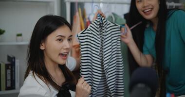 Young Beautiful Asian woman live streaming at clothes shop photo