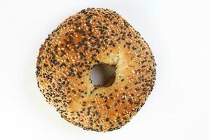 Toasted sliced black seed sesame bagel bread on white background photo