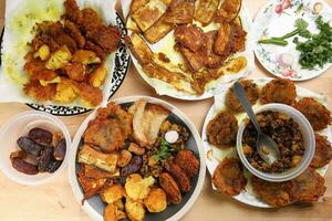 Indian Bengali stye variety fitter deep fried tanpura piaju pakoda battered cauliflower eggplant dumplings chola dal fry dates for iftar breakfast snack comfort food photo