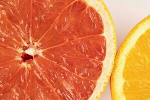 Orange grapefruit slice closeup on white background photo