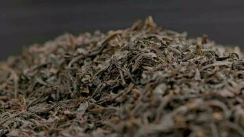 looped spinning dry black tea full frame close-up background video