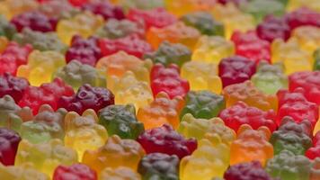 full frame looped spinning background of colorful jelly bear candies video