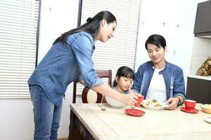 South East Asian young father mother daughter  parent girl child activity indoor photo