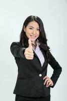 One young asian malaysian business office woman stand smile thumbs up hand sign on white background photo