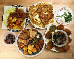 Indian Bengali stye variety fitter deep fried tanpura piaju pakoda battered cauliflower eggplant dumplings chola dal fry dates for iftar breakfast snack comfort food photo