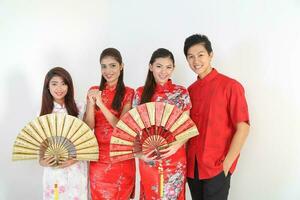 South East Asian young Malay Chinese Indian man woman wearing traditional chinse cheongsam dress on white background shop exchange gift orange greetings share racial unity harmony hand fan photo