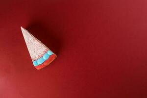 Rainbow crepe layer cake top view red background copy space photo